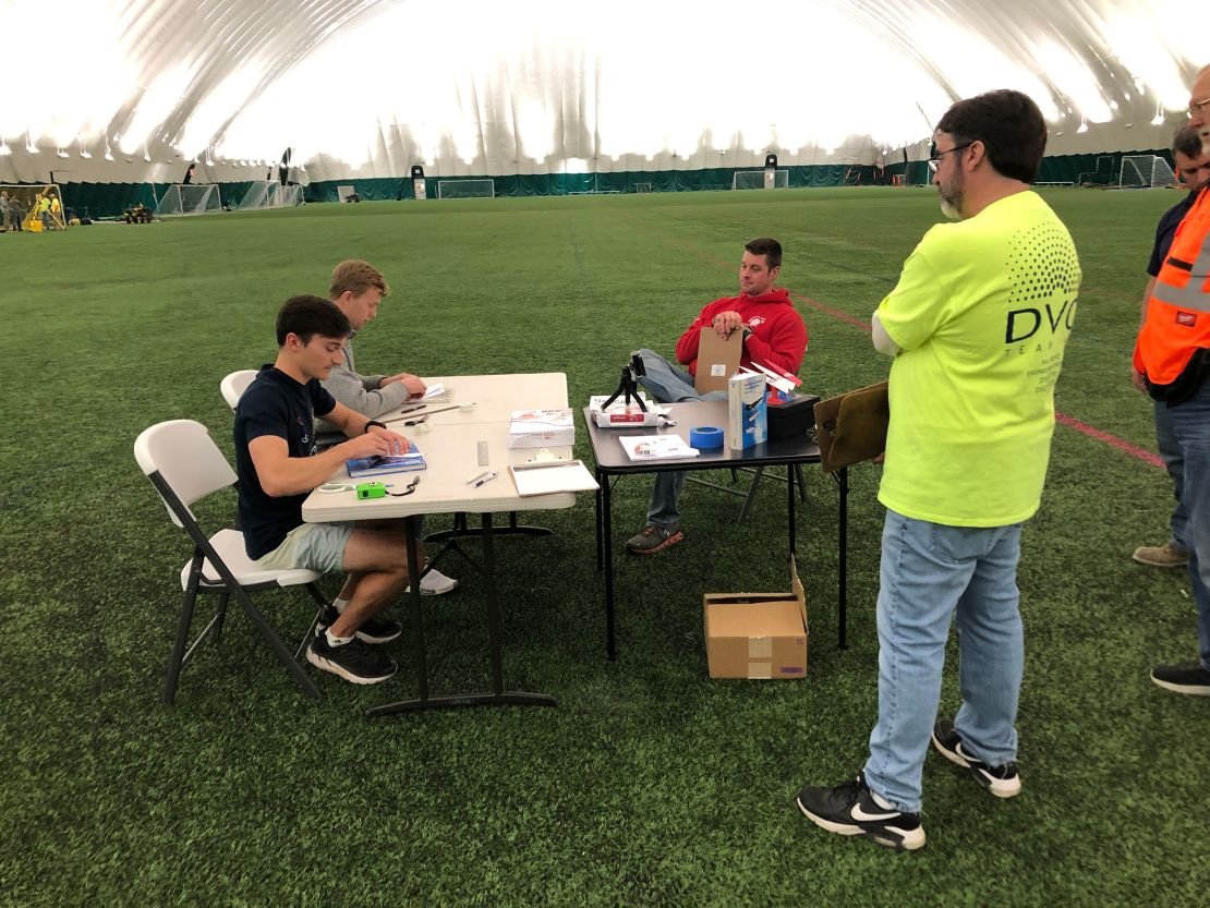 Ruble (from left) and Erickson fold their paper airplanes with witnesses overseeing. The engineers had to pay careful attention to the numerous rules and guidelines set forth by the Guinness World Record Team.